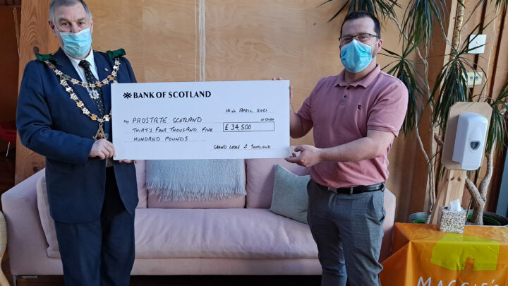 The Grand Master Mason presenting a cheque for £34,500 for Prostate Scotland to Brian Corr